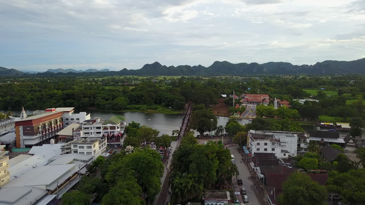 Scenic aerial view of Kanchanaburi city and lush landscape at sunset