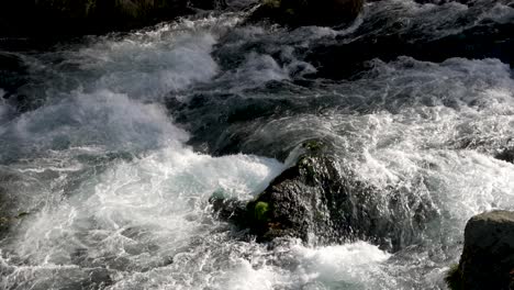 Water-flowing-through-stones,-in-slow-motion