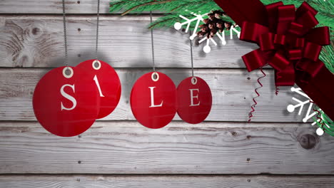 red sale tags hanging against wood with festive decorations