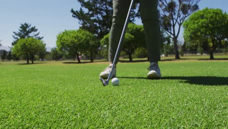 Low-section-of-caucasian-senior-man-practicing-golf-at-golf-course-on-a-bright-sunny-day