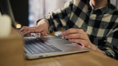 accurate female hands typing something on laptop keyboard.