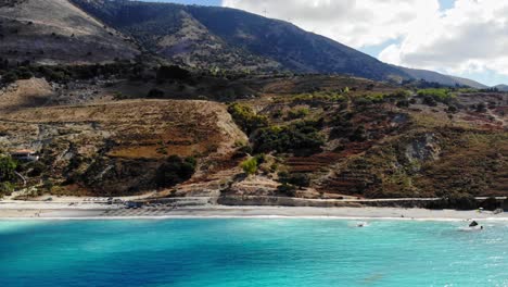 waves crashing in quiet beach of agia kiriaki in kefalonia greece - panning aerial shot