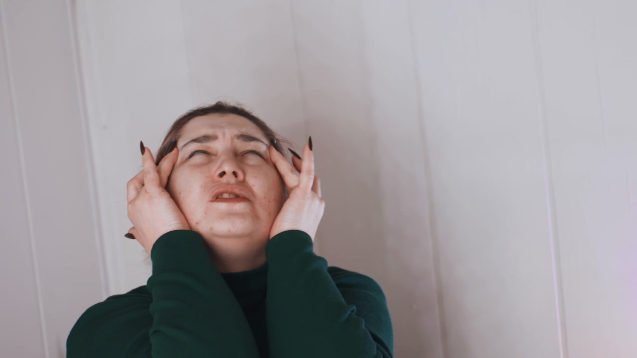 Tired paramedic rests. Paramedic shows signs of fatigue. Exhausted paramedic experiencing severe headache at home. Paramedic after work displaying stress and intense head pain at residence