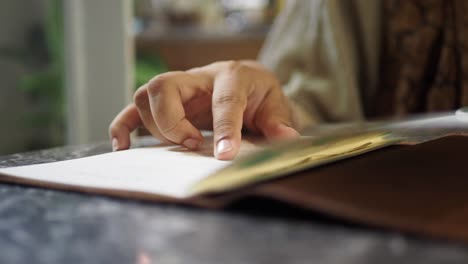 person reading a menu at a cafe