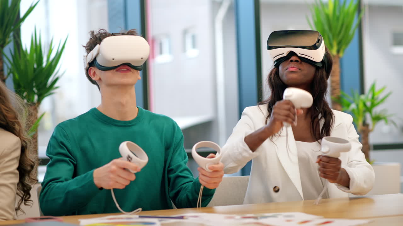 Business conference in VR in an office. Multiracial group of people talking and using VR glasses and controllers, papers on the table