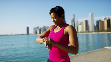 ethnic female resting after workout wearing smart watch