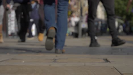 defocused shot of feet walking down cornmarket street in oxford