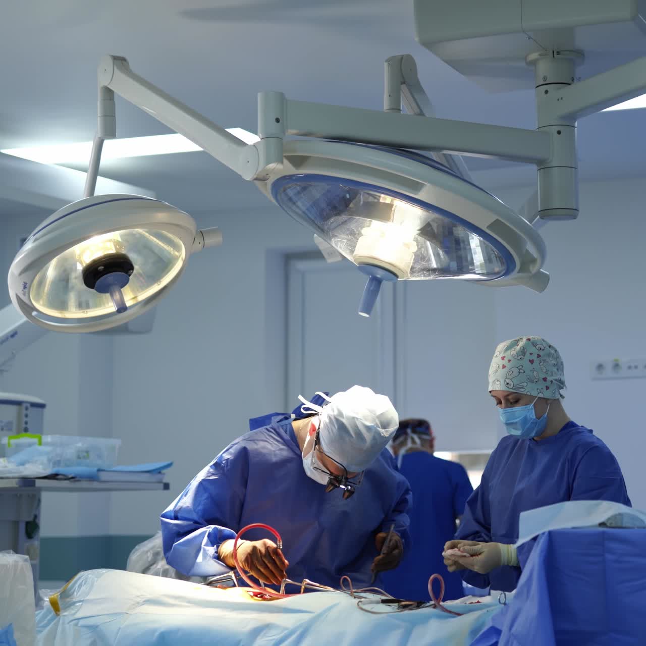 Medical team performing operation. Group of surgeons in stationary operating theater