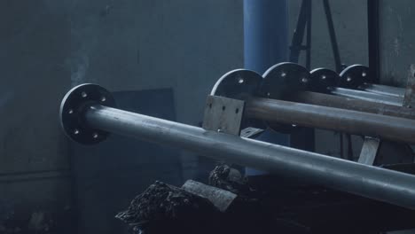 industrial metal pipes and flanges in a factory setting