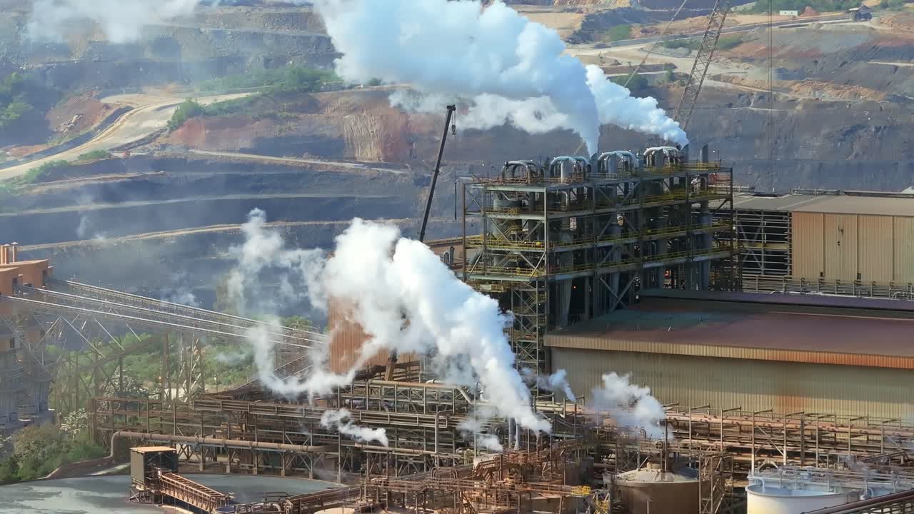 Expansive Barrick Gold and silver mine in Cotui, industrial buildings, processing areas, and surrounding landscape, Dominican Republic. Aerial drone lateral view
