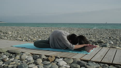 Woman Practicing Yoga on the Beach