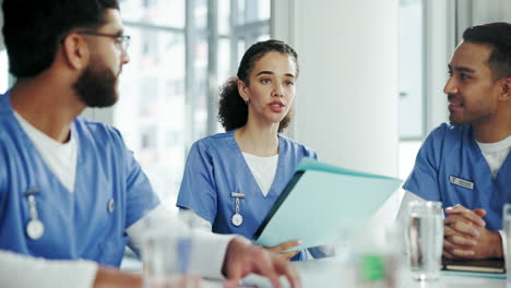 three medical professionals are discussing a patient's chart