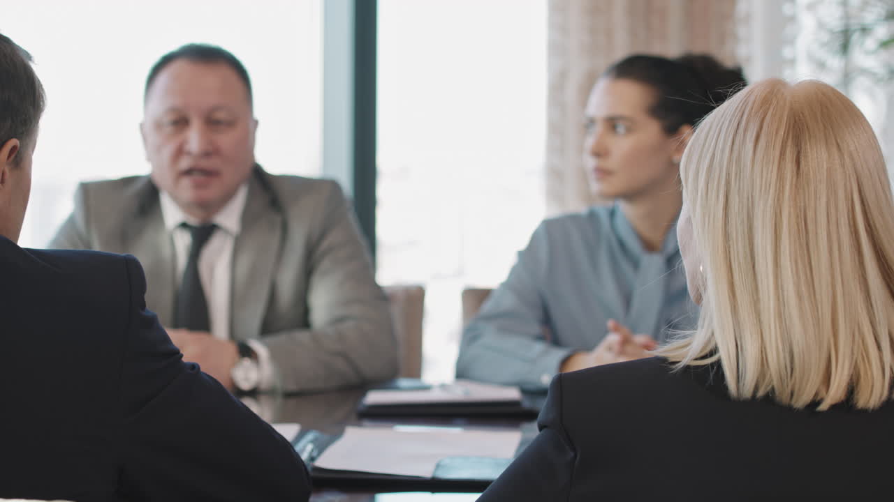 Business Investors Negotiating In Conference Room
