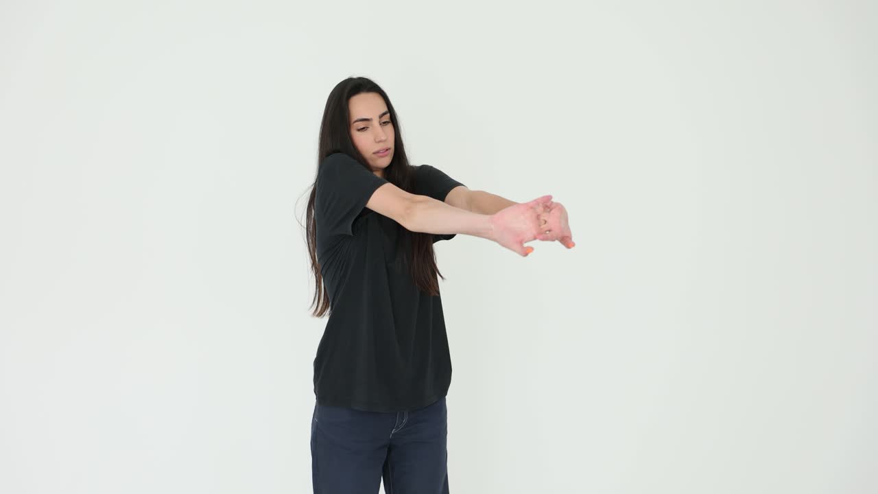 Woman stretching in a black t-shirt and jeans