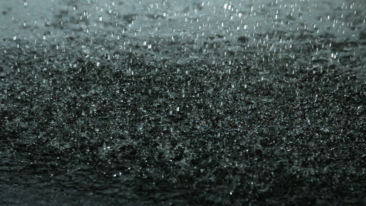 Rain falling on black surface