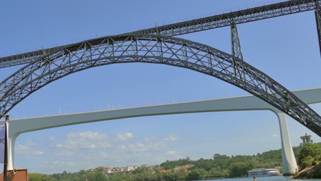 Iconic-Architectural-Of-Maria-Pia-Bridge-Stands-Tall-Over-The-Douro-River-In-Porto,-Portugal