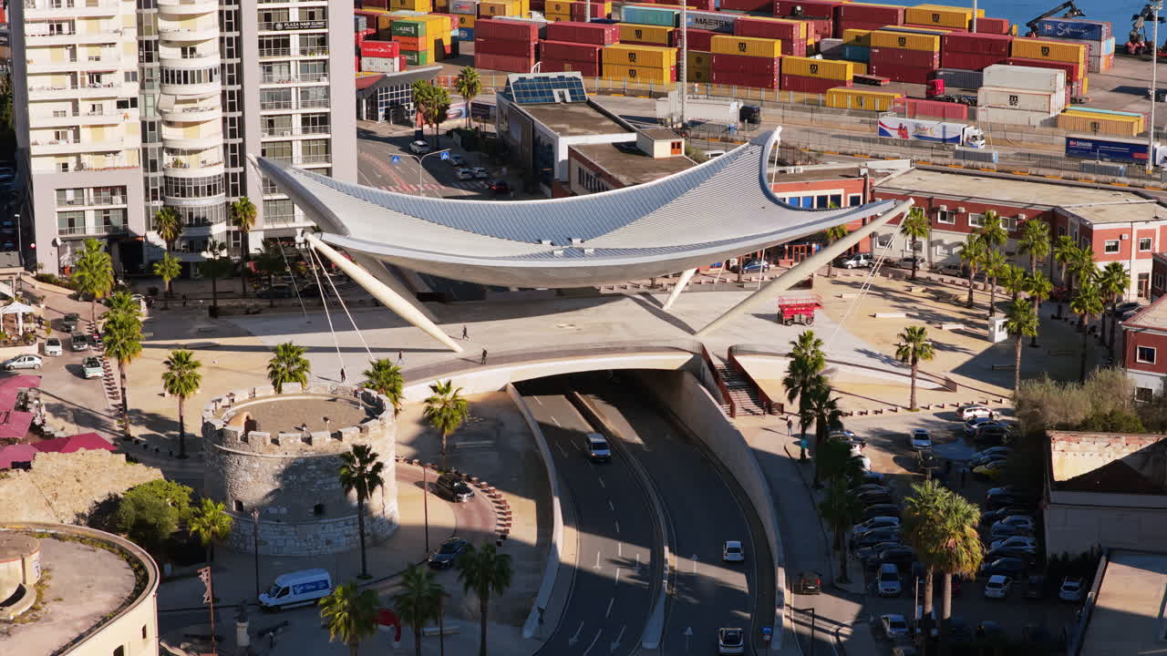 Aerial drone view of the futuristic white, sail shaped pedestrian and vehicular overpass near the port in Durres, Albania