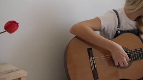 girl playing guitar at home