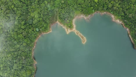 guitar-shaped lake surrounded by forested mountains - lake danao natural park on the island of leyte in philippines