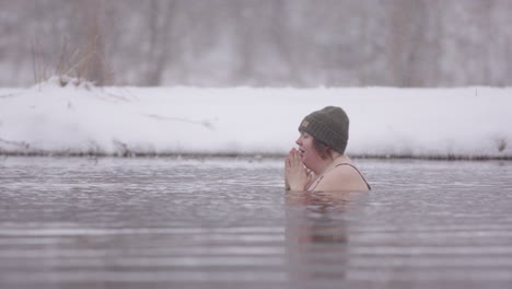 two ice bathers sitting in a frozen lake, swedish winter, pan shot