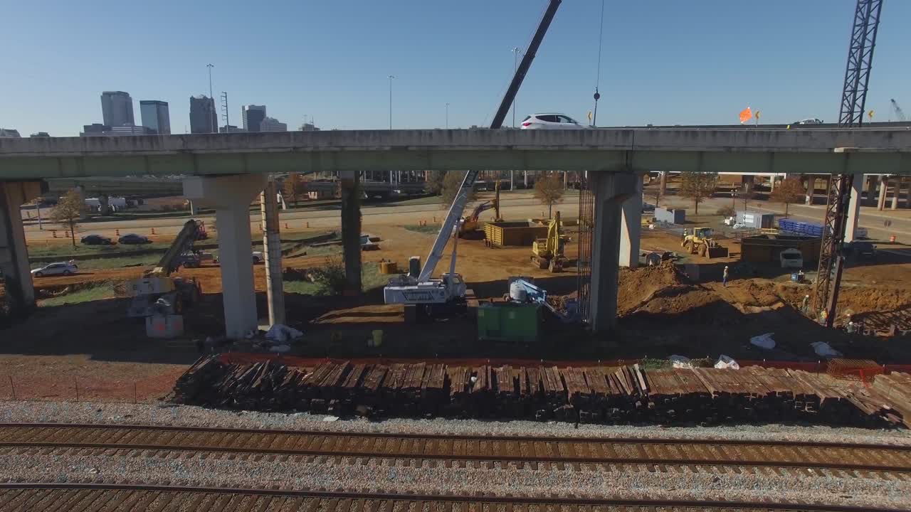 Cars drive over busy city overpass and equipment during on ramp ...
