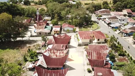 drone flying over traditional batak village on samosir island in lake toba