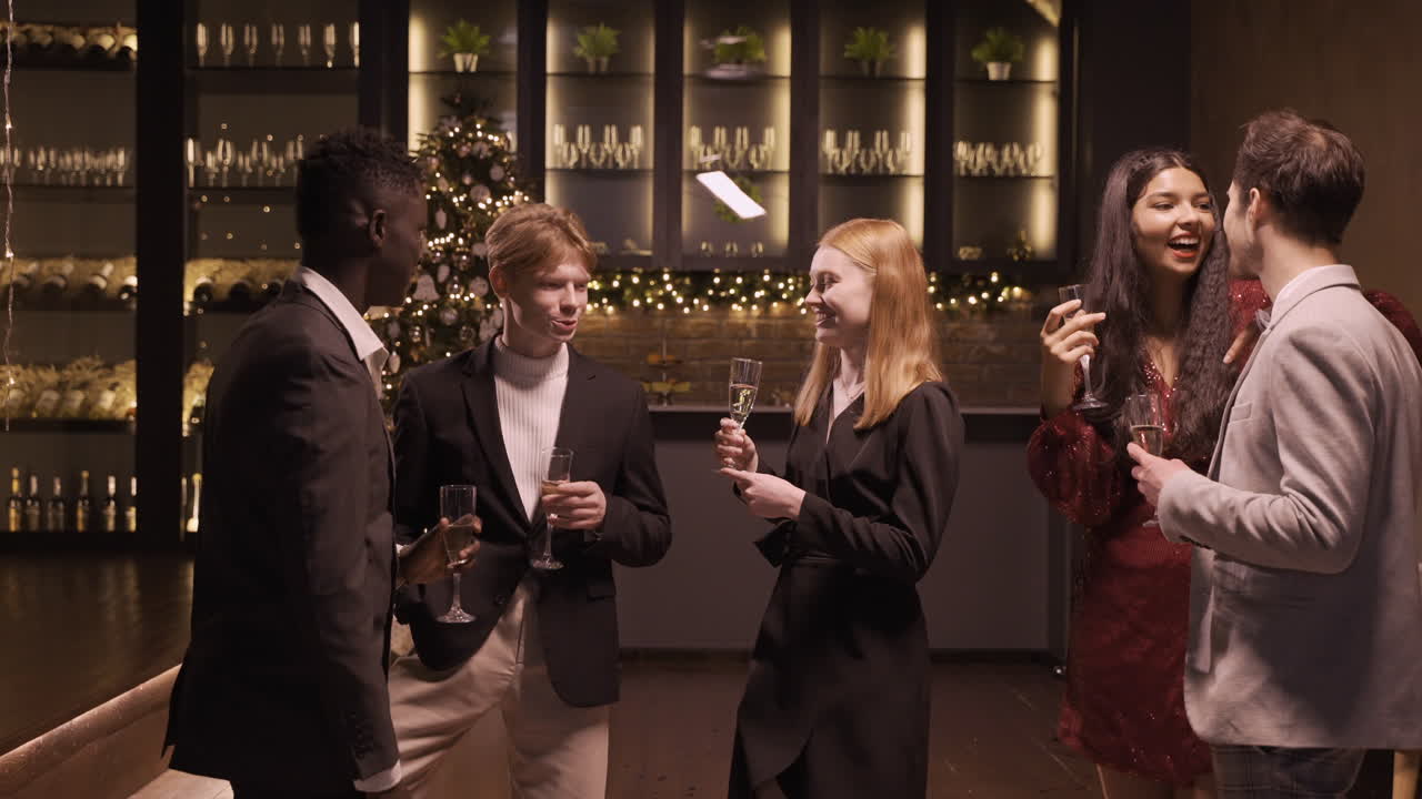 신년 파티에서 샴페인 잔을 들고 이야기하는 우아한 옷을 입은 친구들