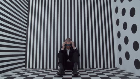 depressed businessman in optical illusion room