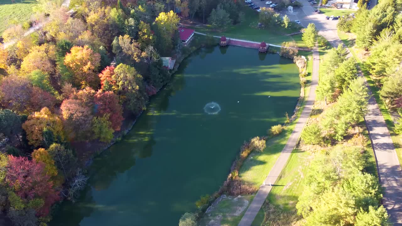 Aerial view of Swan Ghat at ISKCON New Vrindaban, West Virginia, surrounded by vibrant fall foliage and golden autumn trees at this iconic Vaishnavism Hindu temple site