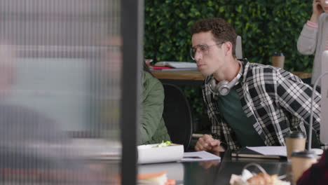 young group of business people working team leader woman training intern pointing at computer screen sharing ideas showing support colleagues collaborating in diverse modern office