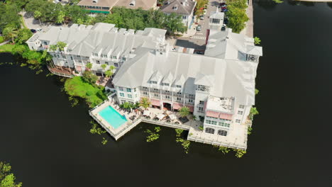 flying over white bohemian marriott hotel in celebration, florida.
aerial drone shot over the lake.