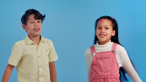 two smiling children in studio portrait
