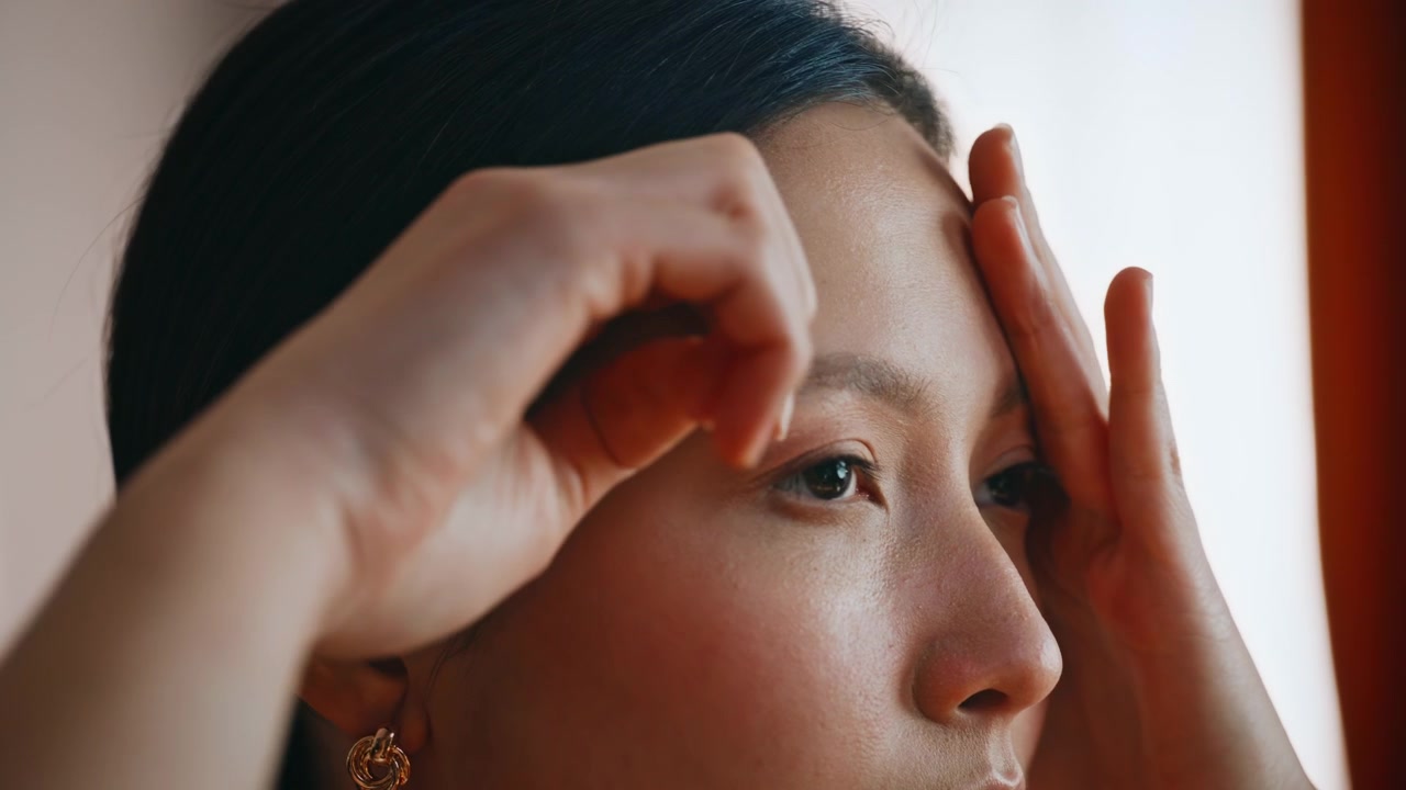 Pensive asian woman touching face fingertips. Closeup portrait thoughtful beauty