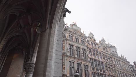 snow falling at the guild houses at brussels grand place in belgium during winter