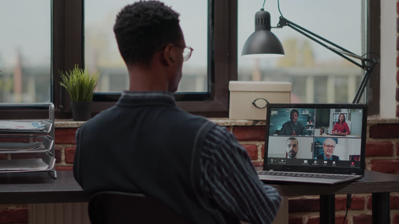 Business man talking to colleagues on online conference call