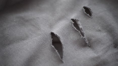 torn grey fabric