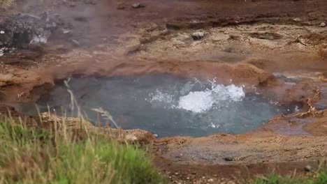 close up of a geothermal geyser with water vaper coming out in iceland