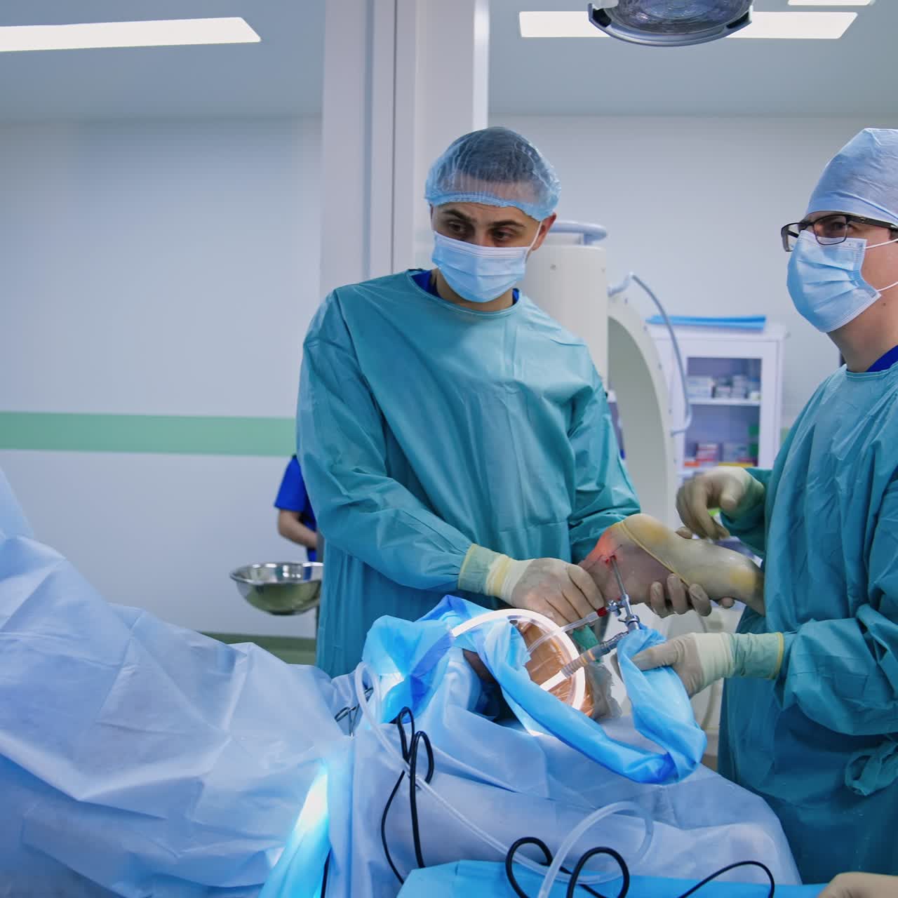 Modern surgical room with advanced equipment. Surgery on foot is carried out by the surgeon and assistant