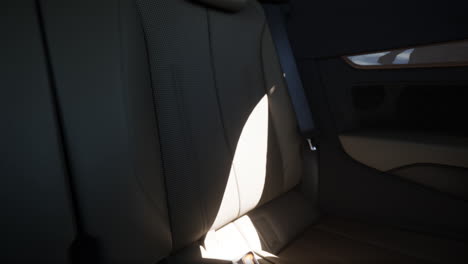 close up of the back seats of a car with perforated leather and tan interior