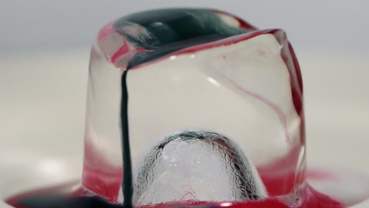 Slow motion paint falling on ice cube shot in macro. Sony a7iii