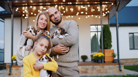 mom, dad, daughter and beloved women. portrait of a family with pets on the background of their home