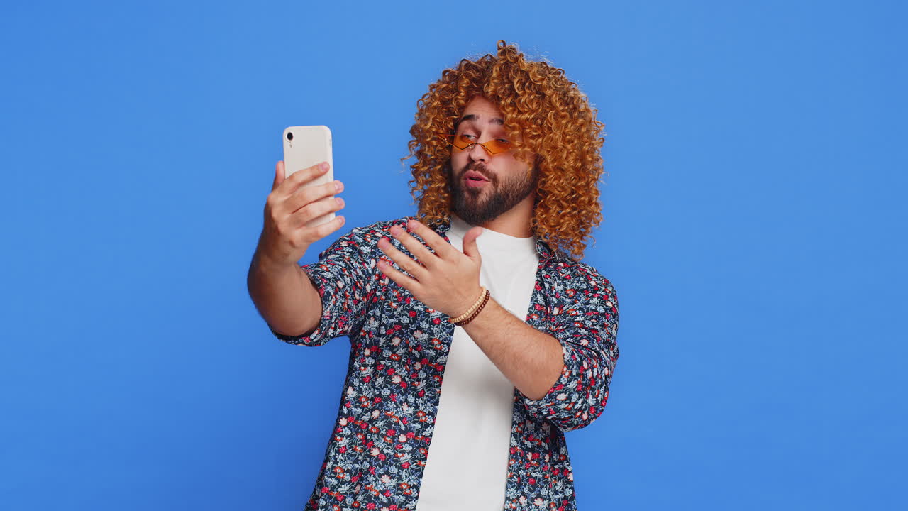Happy man blogger taking portrait selfie record video call online with social media subscribers