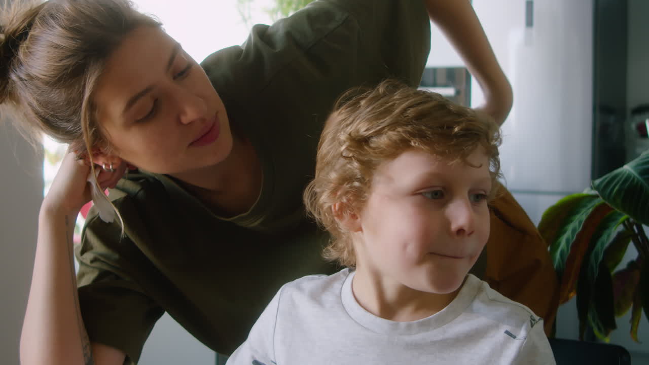 Loving Mother Talking with Little Son at Breakfast