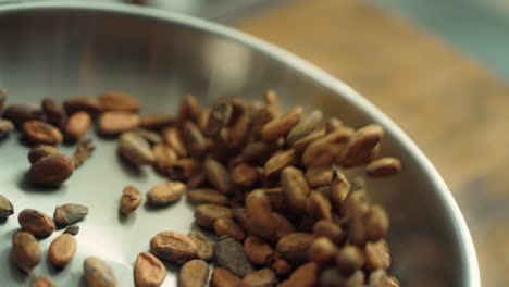 Cacao-grains-roasting-in-pan-in-slow-motion.-Close-up-cocoa-beans-tossing-in-pan