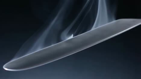 smoke surrounding a steel blade