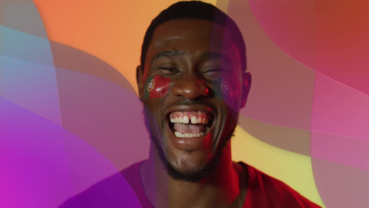 Animation of african american male supporter with flag of portugal over shapes