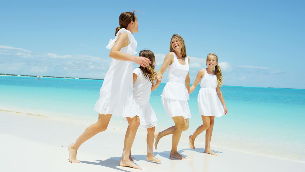 Caucasian girls with their mother enjoying beach vacation