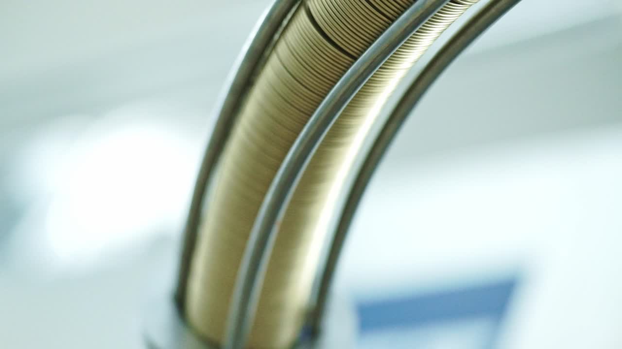 Gold can tops being fed into the production line of a beverage canning factory