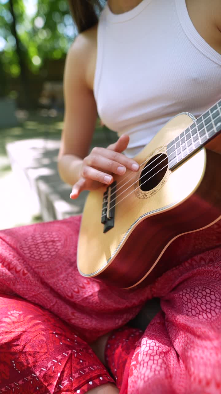 mujer tocando el ukulele al aire libre