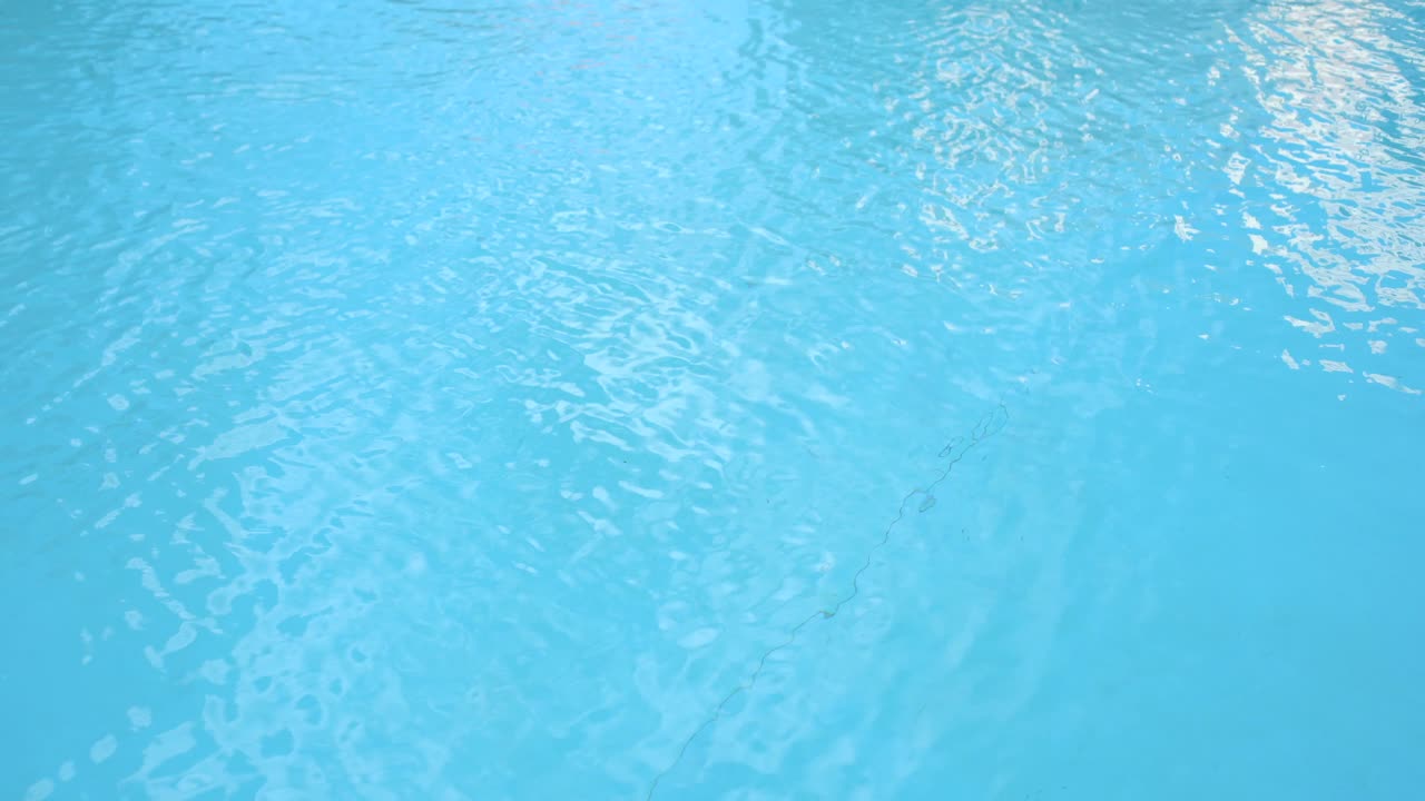 Water surface texture, Slow motion clean swimming pool ripples and wave, Refraction of sunlight top view texture sea side white sand, sun shine water background. Water Caustic Background.